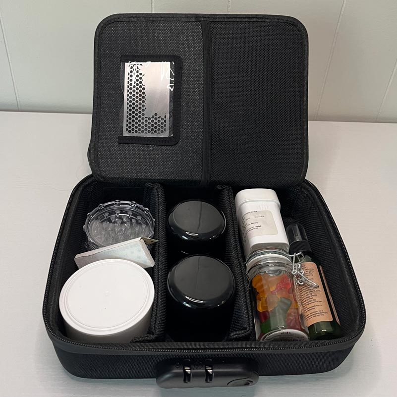 Open LOCKGREEN stash box interior with organized jars, grinder, and storage compartments